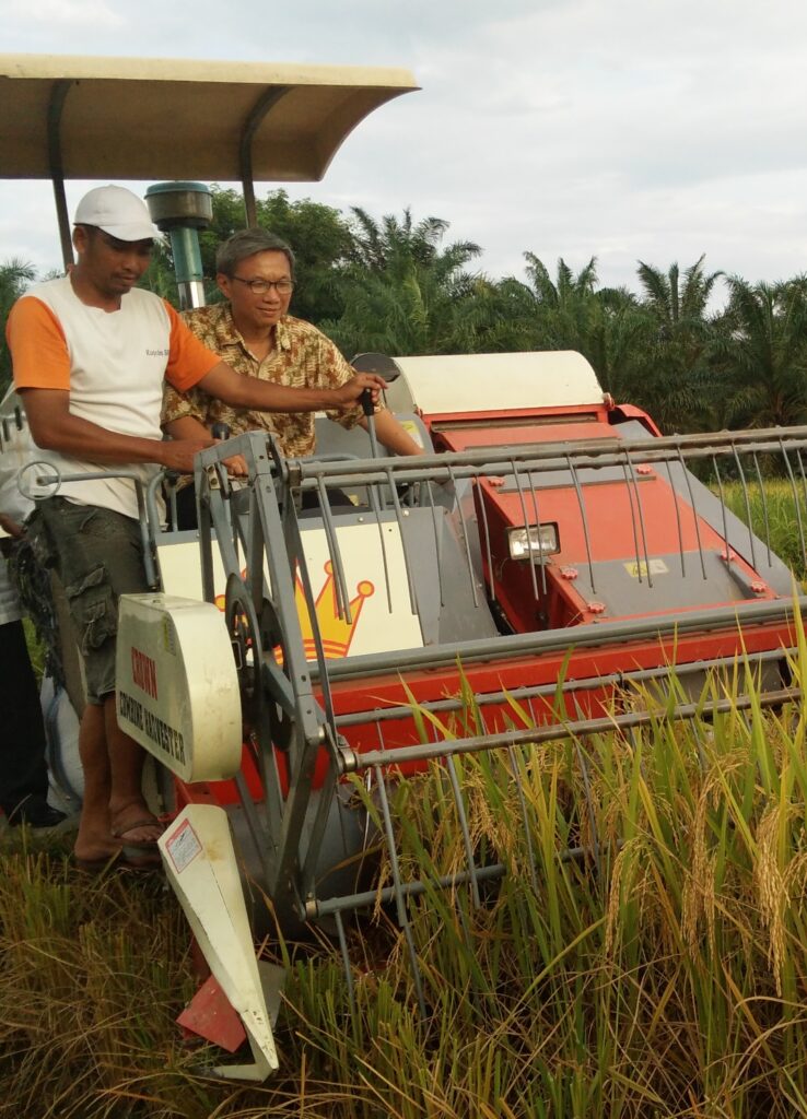 The author is seen on a tractor in Bengkulu, Indonesia